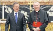  ?? EPA ?? South Korean President Moon Jae-in, left, poses for a portrait with Cardinal Secretary of State Pietro Parolin during a special Mass for peace on the Korean Peninsula at St Peter’s Basilica in the Vatican yesterday.