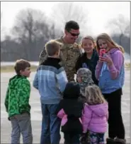  ?? MARIAN DENNIS – DIGITAL FIRST MEDIA ?? Chad Carvalho, 34, an Army maintenanc­e test pilot originally from Pottstown, greets his nieces and nephews as he arrives at Heritage Field Airport.