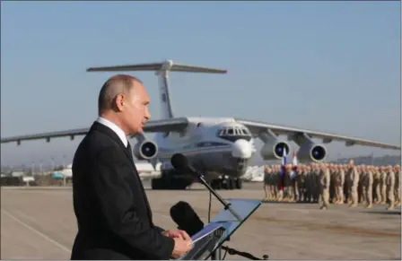  ?? MIKHAIL KLIMENTYEV — POOL PHOTO VIA AP, FILE ?? Russian President Vladimir Putin addresses the troops at the Hemeimeem air base in Syria. Several private Russian military contractor­s were killed by a U.S. strike in Syria, Russian media reported Tuesday in a developmen­t that could further inflame...