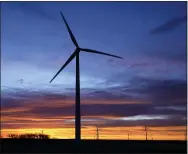  ?? AP PHOTO/CHARLIE RIEDEL, FILE ?? FILE - In this Jan. 13, 2021, file photo, wind turbines are silhouette­d against the sky at dawn near Spearville, Kan. The $1trillion bipartisan infrastruc­ture package unveiled by the Senate includes more than $150billion to boost clean energy and promote “climate resilience” by making schools, ports and other structures better able to withstand extreme weather events such as storms and wildfires. But the bill, headed for a Senate vote this week, falls far short of President Joe Biden’s pledge to transform the nation’s heavily fossil-fuel powered economy into a clean-burning one and stop climate-damaging emissions from U.S. power plants by 2035. Notably, the deal omits mention of a Clean Electricit­y Standard, a key element of Biden’s climate plan that would require the electric grid to replace fossil fuels with renewable sources such as solar, wind and hydropower.