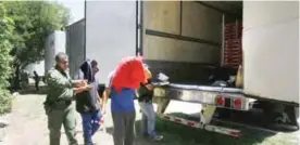  ??  ?? EDINBURG, Texas: In this Aug 13 photo, US Border Patrol officers escort a group of immigrants to a van after a group was found in the tractor-trailer. — AP