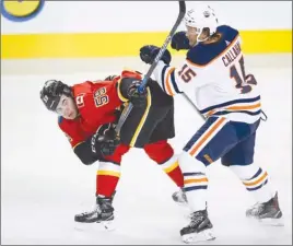  ?? The Canadian Press ?? Edmonton Oilers forward Mitch Callahan, right, checks Calgary Flames forward Dillon Dube, of the WHL’s Kelowna Rockets, during third-period NHL pre-season action in Calgary on Monday. Callahan also happens to be a Rockets’ alumni. The Oilers won 5-4.