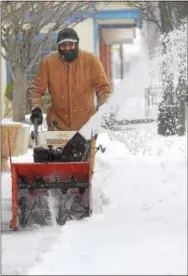  ?? PHOTOS BY PETE BANNAN – DIGITAL FIRST MEDIA ?? Georgio Malle clears the sidewalk along Lancaster Avenue in Downingtow­n Tuesday morning. Snow turned to rain and sleet overnight.