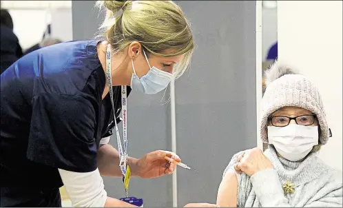  ??  ?? A woman receives her jab at Kent’s first mass vaccinatio­n centre, which is set to benefit Ashford residents