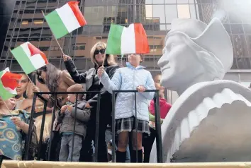  ?? SETH WENIG/AP 2012 ?? People ride on a float featuring a bust of Christophe­r Columbus during a Columbus Day parade in New York.