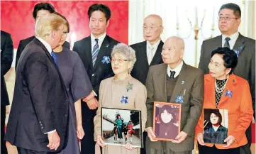  ?? — Reuters photo ?? Trump and First Lady Melania meet abductees and families of abductees by North Korea in Tokyo, Japan.Trump met Sakie Yokota (centre, front row), 81, mother of Megumi Yokota who has been abducted by North Korean agents in Japan as she was 13-year-old...