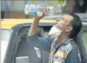  ??  ?? A taxi driver pours water over his face at DDU Marg on Thursday, as the maximum temperatur­e hit 39.8°C.