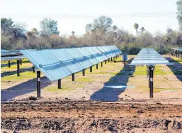  ?? ?? Rows of solar panels sit at Orsted’s Eleven Mile Solar Center lithium-ion battery storage energy facility on February 29, 2024, in Coolidge, Arizona.
