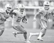  ?? JIM RASSOL/STAFF FILE PHOTO ?? Cornerback Bobby McCain (28) had this late intercepti­on against the New York Jets that set up the winning field goal.