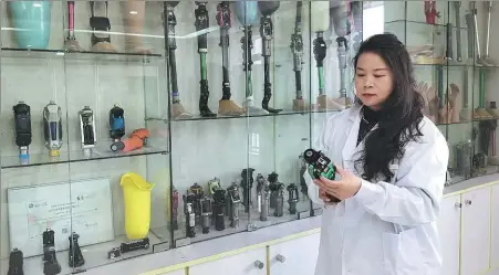  ?? PROVIDED TO CHINA DAILY ?? Li Juan checks a product in her company’s showroom in Wuhan, Hubei province.