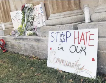  ?? MICHAEL THOMAS / GETTY IMAGES ?? Signs are shown on display outside the Chesed Shel Emeth Cemetery on Feb. 22 in University City, Missouri. Missouri Gov. Eric Greitens and U.S. Vice President Mike Pence were on hand to speak to more than 300 volunteers cleaning up after recent...