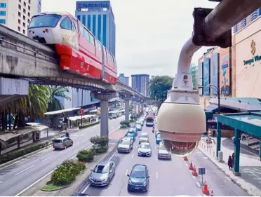  ??  ?? Keeping an eye: A security camera on the streets of Kuala Lumpur.