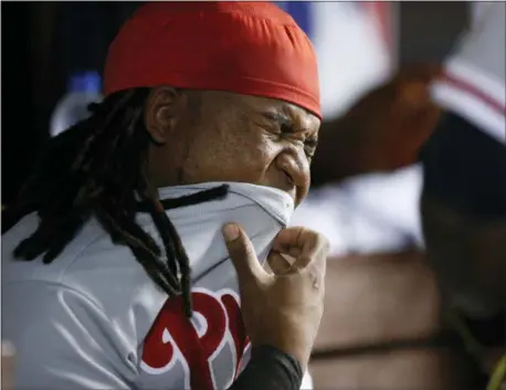  ?? BRYNN ANDERSON — ASSOCIATED PRESS ?? Phillies third baseman Maikel Franco reacts after getting eye drops put in his eyes during Saturday’s game against the Marlins in Miami.