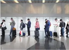  ??  ?? Passengers at O’Hare wait in line at a TSA checkpoint in May 2016.