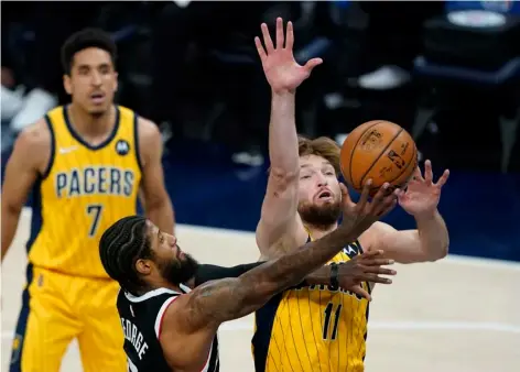  ?? AP Photo/Darron Cummings ?? Los Angeles Clippers’ Paul George (13) puts up a shot against Indiana Pacers’ Domantas Sabonis (11) during the first half of an NBA basketball game, on Tuesday in Indianapol­is.