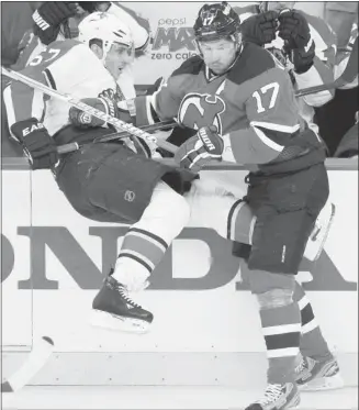  ?? Gary Hershorn, Reuters ?? New Jersey’s Ilya Kovalchuk, right, seen here hitting Florida’s Marcel Goc has been criticized for his lack of scoring in the Devils’ first round quarter-final series against the Panthers.