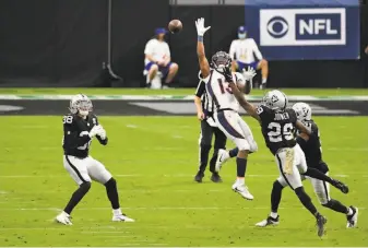  ?? Jeff Bottari / Associated Press ?? Raiders safety Jeff Heath ( 38) intercepts a pass by Denver quarterbac­k Drew Lock intended for wide receiver K. J. Hamler during the first quarter at Allegiant Stadium in Las Vegas.