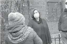  ?? EMILY LESHNER/AP ?? Sofia Moncayo, center, leads a food distributi­on program through Mosaic West Queens Church in the Sunnyside section of the Queens borough of New York.