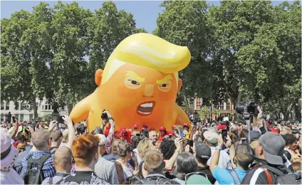  ?? Picture: AFP ?? CRY BABY. Activists inflate a giant balloon depicting US President Donald Trump as an orange baby during a demonstrat­ion against his visit to the UK in Parliament Square in London yesterday.