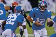  ?? BRYAN WOOLSTON — THE ASSOCIATED PRESS ?? Nine-year NFL veteran Colt McCoy, right, will likely start at quarterbac­k for the Giants in place of Daniel Jones, who is doubtful with a hamstring injury.