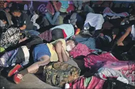  ?? HONDURAN MIGRANTS Johan Ordonez AFP/ Getty I mages ?? rest after crossing into Guatemala on Thursday. Poverty, violence and f lagrant government corruption have worsened with COVID- 19.