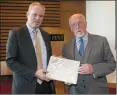  ??  ?? CEO Ciarán Hayes presents Cllr Sean McManus with photo book