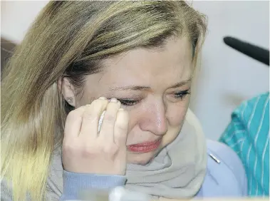  ?? LARRY WONG/Postmedia News ?? Shelly MacInnis-Wynn, wife of RCMP Const. David Matthew Wynn, breaks down in tears while speaking about her husband Monday. Const. Wynn, a 42-year-old married father of three, was one of two RCMP officers shot by Shawn Rehn. Wynn remains in hospital in...