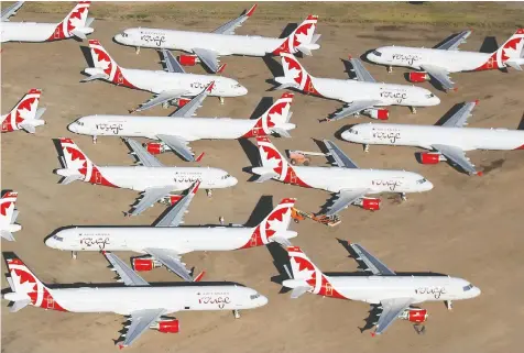  ?? — CHRISTIAN PETERSEN/GETTY IMAGES ?? Decommissi­oned and suspended Air Canada commercial aircraft are stored in Pinal Airpark on Saturday in Marana, Ariz. The COVID-19 pandemic has had a significan­t impact on commercial airlines.