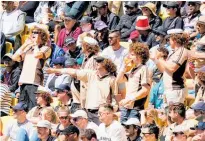  ?? Photos / Alex Burton, Photosport ?? Ponsonby’s cafe set was out in level 2 force yesterday and, right, a level 1 crowd cheered on the Black Caps against Australia in Wellington.