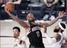  ?? AP file photo ?? The Rockets’ P.J. Tucker grabs a rebound between the Lakers’ Danny Green and Markieff Morris during a playoff game on Sept. 12. Tucker is reportedly unhappy in Houston because he hasn’t been given an extension.