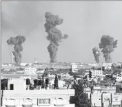  ?? Said Khatib
AFP/Getty Images ?? SMOKE RISES after an Israeli airstrike in July on the airport in Rafah in the southern Gaza Strip.