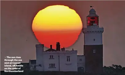  ?? Owen Humphreys ?? The sun rises through the sea mist at Coquet island, off Amble on the coast of Northumber­land