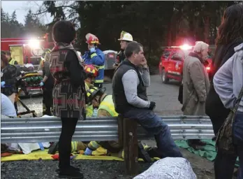  ??  ?? In this December file photo provided by Daniella Fenelon, first responders work at the scene of an Amtrak train that derailed in DuPont, Wash. Dozens of 911 call recordings released by South Sound 911 Dispatch provide a vivid account of the Dec. 18...