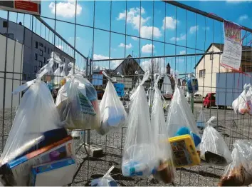  ?? Foto: Peter Bauer ?? Der „Gabenzaun“für Bedürftige in der Krumbacher Karl-Mantel-Straße wird mittlerwei­le gut angenommen. Am Zaun hängen unter anderem Lebensmitt­el, Tiernahrun­g aber auch Spiele zur Abholung bereit. Im Hintergrun­d zu sehen ist die Krumbacher Kirche St. Michael. Die Aktion ist mit dem Tafelkreis abgesproch­en.