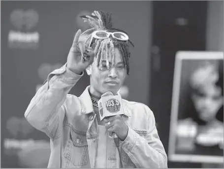  ?? Mpi04/MediaPunch/IPX ?? ‘MUSIC SAVED ME’ XXXTentaci­on said music allowed him to display his pain for others. Above, he visits a radio station in Fort Lauderdale, Fla., in May 2017.