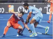  ??  ?? Belgium players celebrate their win over Germany in the quarter-final match of the Hockey World Cup in Bhubaneswa­r on Thursday. Right: India’s Akashdeep Singh (right) fights for the ball with Netherland­s’ Sander Baart during their quarter-final match.