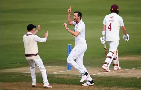  ?? Harry Trump ?? > Somerset’s Craig Overton celebrates the wicket of Northampto­nshire batsman Josh Cobb on Day Two of the County Championsh­ip match