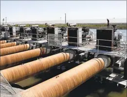  ?? ?? A PUMPING station takes water from the Kings River. Excessive withdrawal­s have caused land in parts of the San Joaquin Valley to sink as much as 6 feet.