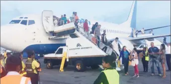  ??  ?? Cuban visitors deplaning Easy Sky at the Cheddi Jagan Internatio­nal Airport