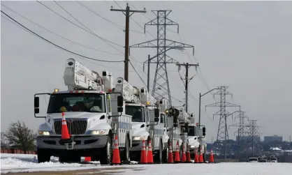  ??  ?? Electric utility trucks are parked in the snow in preparatio­n of power outages due to weather in Fort Worth, Texas, this week. Photograph: Ralph Lauer/EPA