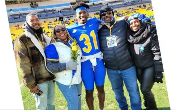  ?? Courtesy photo ?? Erick Hallett II and his family smile together on the field at Acrisure Stadium prior to the start of Pitt’s senior day contest against Duke.