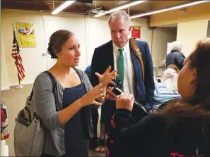  ?? Photo by Joseph B. Nadeau ?? Katie Cardamone, a Spanish immersion program coordinato­r for the Mendon-Upton School District, and Mendon-Upton Superinten­dent Joseph Maruszczak, both backers of the proposed Nuestro Mundo Charter School, tell Woonsocket parent Brenda Lee McGovern how their proposed bilingual immersion program would work. The Rhode Island Department of Education held a hearing on the Nuestro Mundo proposal on Wednesday in the Woonsocket Public Library conference room.