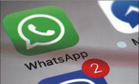  ?? PATRICK SISON / ASSOCIATED PRESS ?? WhatsApp, a popular messaging service whose icon is seen above on a smartphone, has been partly blocked in China.
