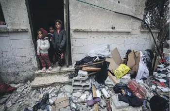  ?? WASHINGTON POST ?? Palestinia­n children in the rubble of the al-Nahhal family home after an Israeli air strike on the Rafah refugee camp in southern Gaza.