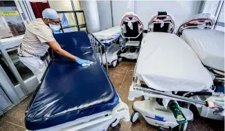  ?? ?? A medical worker cleans gurneys in the emergency department intake area at NYC Health + Hospitals Metropolit­an in New York, May 27, 2020.