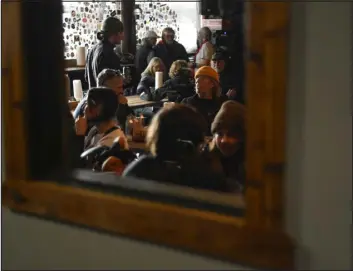  ?? ALEX GOODLETT — THE NEW YORK TIMES ?? Patrons gather at the Powder Keg, inside the Timberline Lodge, at Powder Mountain in Eden, Utah, in March.