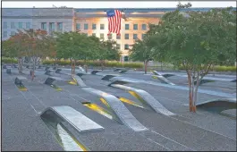  ?? (File Photo/ap/jacquelyn Martin) ?? A U.S. flag is draped in September 2015 on the side of the Pentagon where the attack took place 14 years earlier, seen from the Pentagon Memorial.