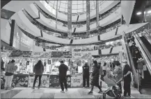  ?? YANG KEJIA / CHINA NEWS SERVICE ?? People shop at a mall in Beijing’s Tongzhou district on Sunday. Some malls in the capital resumed operations over the weekend.