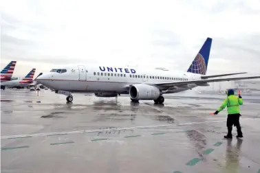  ?? AP PHOTO/TED SHAFFREY ?? A Boeing 737-700 United Airlines flight from West Palm Beach, Fla., taxis Jan. 12 at Newark Liberty Internatio­nal Airport in Elizabeth, N.J.