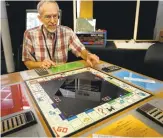  ?? PATRICK TEHAN/ STAFF ?? Stephen Casner, of Sunnyvale, describes his invention, a “solid state” Monopoly game, which was on display during the Vintage Computer Festival in Mountain View on Saturday.